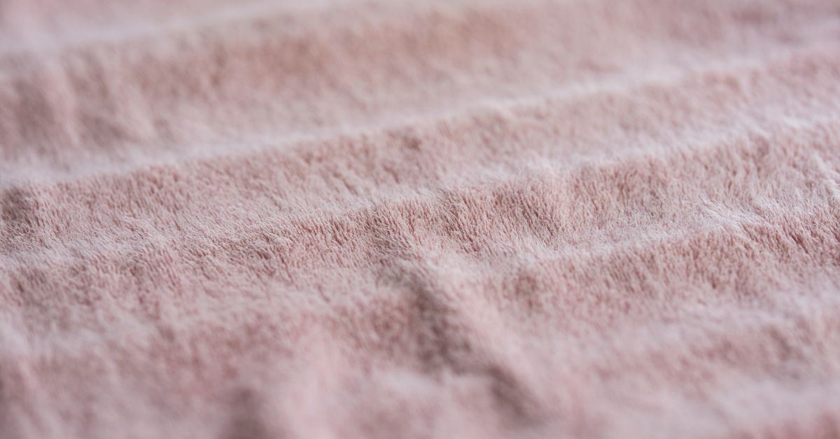 Detailed close-up of a soft pink cotton towel showcasing its texture and fabric quality.
